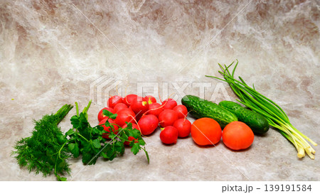 vegetable assortment of radishes cucumbers and greens on a light background vegetable assortment of radishes cucumbers and greens on a light background 139191584