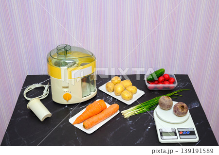 variety of fresh vegetables and kitchen appliances on the dark marble surface of the table variety of fresh vegetables and kitchen appliances on the dark marble surface of the table 139191589