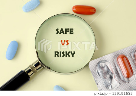 Magnifying glass highlights SAFE vs RISKY text on a light background Magnifying glass highlights SAFE vs RISKY text on a light background 139191653