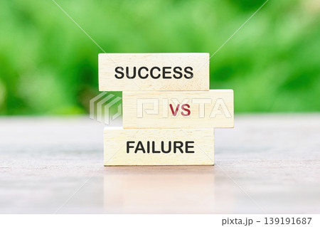 Three wooden blocks stacked vertically on a light surface. The blocks display the words SUCCESS VS FAILURE, symbolizing a critical choice or comparison Three wooden blocks stacked vertically on a light surface. The blocks display the words SUCCESS VS FAILURE, symbolizing a critical choice or comparison 139191687