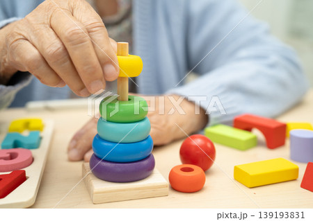 Alzheimer disease AD, Asian elderly woman patient suffering from dementia learn practical motor skills rehabilitation. 139193831