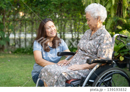 Caregiver help and care Asian senior woman patient sitting on wheelchair at nursing hospital ward, healthy strong medical. 139193832