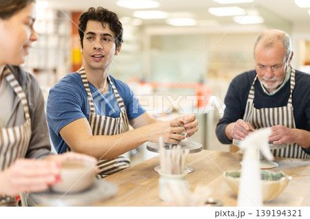 Young woman and man and elderly man crafting ceramics Young woman and man and elderly man crafting ceramics 139194321