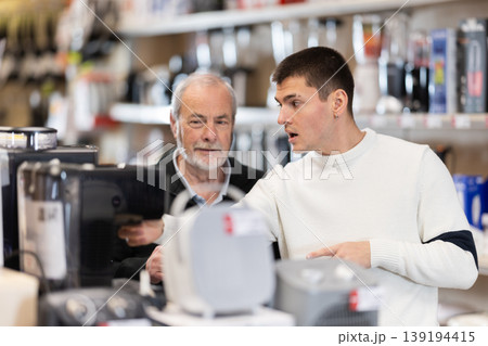 Eldery and young man choosing coffee machine Eldery and young man choosing coffee machine 139194415