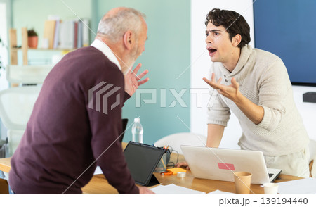 Elderly and young men arguing loudly in office Elderly and young men arguing loudly in office 139194440