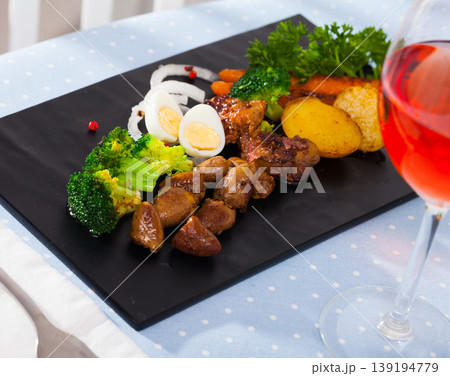 Top view of tasty chicken hearts with baked potatoes, eggs and vegetables Top view of tasty chicken hearts with baked potatoes, eggs and vegetables 139194779