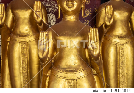 Cropped shot view of golden Buddha statues situated in Wat Sri Donsak, Bokeo province of Laos. Cropped shot view of golden Buddha statues situated in Wat Sri Donsak, Bokeo province of Laos. 139194815