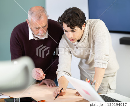 Engineer and architect discussing about blueprint layout design of electricity plan before construction in office Engineer and architect discussing about blueprint layout design of electricity plan before construction in office 139194917