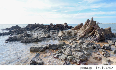 Rugged Dark Rock Formations on Tropical Shoreline Rugged Dark Rock Formations on Tropical Shoreline 139195202