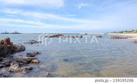 Rocky Shoreline and Long Pier at Tanjung Ular Beach 139195206