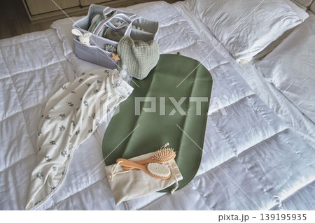 Baby care products on bed for hygiene and wellness Baby care products on bed for hygiene and wellness 139195935