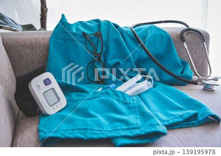 Healthcare worker uniform with medical equipment on sofa Healthcare worker uniform with medical equipment on sofa 139195978