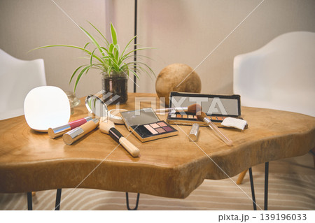 Makeup brushes and beauty products on wooden table 139196033