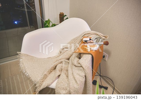 Applying makeup on a modern chair with comfort blanket 139196043