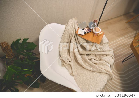 Cosmetics and beauty products on cozy chair Cosmetics and beauty products on cozy chair 139196047