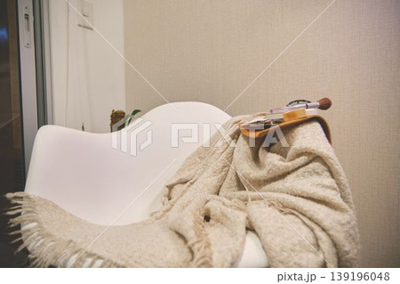 Cozy armchair with blanket and makeup for self-care Cozy armchair with blanket and makeup for self-care 139196048
