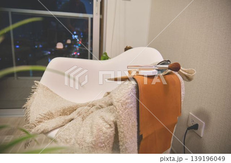 Self-care and beauty items on chair at night Self-care and beauty items on chair at night 139196049