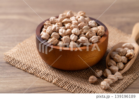 Organic raw chickpeas in a wooden bowl, healthy food ingredient Organic raw chickpeas in a wooden bowl, healthy food ingredient 139196189