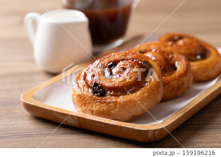 Pain au Raisin, Cinnamon Raisin Swirl and hot coffee, Delicious breakfast Pain au Raisin, Cinnamon Raisin Swirl and hot coffee, Delicious breakfast 139196216