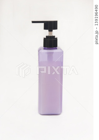 Purple shampoo bottle with black pump on a white background. Purple shampoo bottle with black pump on a white background. 139196490