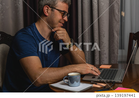Focused freelancer working on laptop at home office at night 139197441