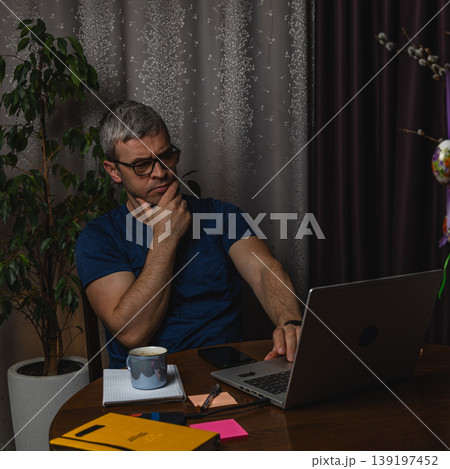Freelancer working calmly on laptop at home office Freelancer working calmly on laptop at home office 139197452