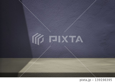 Concrete Beige Table Set Against Blue Stucco Wall Backdrop, with diagonal light beam and shadow Concrete Beige Table Set Against Blue Stucco Wall Backdrop, with diagonal light beam and shadow 139198395