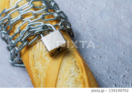 Baguette with chain and lock symbolizing restricted diet Baguette with chain and lock symbolizing restricted diet 139199702