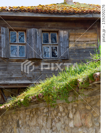 a vintage Bulgarian seaside house with wooden siding and tiled roof 139200276