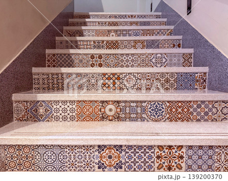 Decorative staircase with colorful patterned tiles, geometric motifs, and artistic design. Interior detail highlighting cultural style, craftsmanship, and vibrant ornamental steps in architectural 139200370