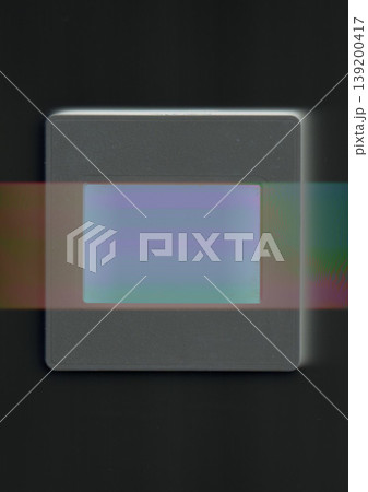 Minimalist conceptual art of a vintage film slide with a prismatic light leak and glitch effect on a black background, representing analog nostalgia and modern digital distortion trends. 139200417