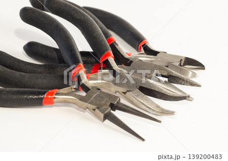 Set of different types of pliers and side cutters isolated on black background. 139200483