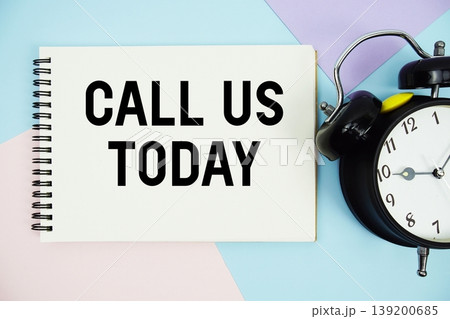 Call Us Today text written on notepad with alarm clock flat lay on multicolor pastel background 139200685