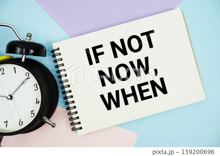 If Not Now, When text written on notepad with alarm clock flat lay on multicolor pastel background If Not Now, When text written on notepad with alarm clock flat lay on multicolor pastel background 139200696