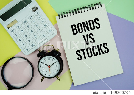 Bonds Vs Stocks text with calculator, alarm clock and magnifying glass 139200704