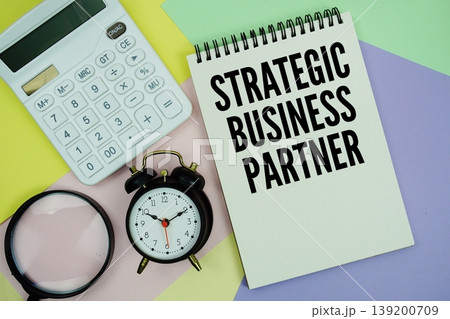 Strategic Business Partner text with calculator, alarm clock and magnifying glass 139200709