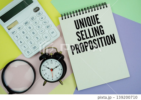 Unique Selling Proposition text with calculator, alarm clock and magnifying glass 139200710