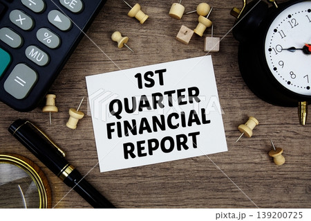 1st Quarter Financial Report text written on notepad with pen, alarm clock, magnifying glass and calculator on wooden background 1st Quarter Financial Report text written on notepad with pen, alarm clock, magnifying glass and calculator on wooden background 139200725