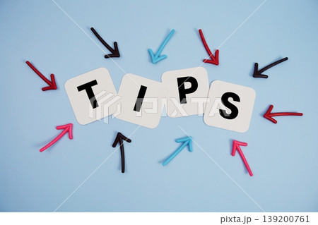 word "TIPS" on cards with colorful arrows pointing toward it, highlighting the concept of instruction 139200761