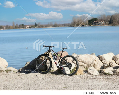 Mountain bike standing on rocks near tranquil lake Mountain bike standing on rocks near tranquil lake 139201059