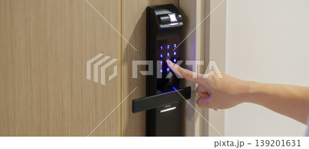 Hand press PIN number for smart digital door lock while open or close the door at home or apartment. NFC Technology, Fingerprint scan, keycard, smartphone and contactless lifestyle concepts Hand press PIN number for smart digital door lock while open or close the door at home or apartment. NFC Technology, Fingerprint scan, keycard, smartphone and contactless lifestyle concepts 139201631