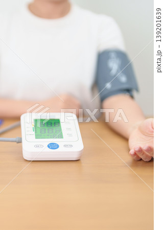 woman checking Blood pressure by Blood pressure monitor with Cuff. Systolic, SYS, Diastolic, DIA, Pulse, Hypertension, Hypotension, Heart rate, Cardiovascular Disease and May World hypertension day woman checking Blood pressure by Blood pressure monitor with Cuff. Systolic, SYS, Diastolic, DIA, Pulse, Hypertension, Hypotension, Heart rate, Cardiovascular Disease and May World hypertension day 139201639