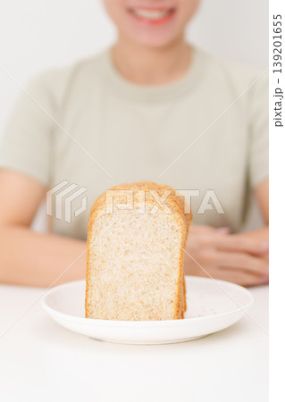 Happy smiling woman with whole wheat bread. Weight loss management, Dieting, Healthy eating, Calorie control, Fitness food, High fiber, Wellness, Lifestyle, Metabolism and Glycemic Index Happy smiling woman with whole wheat bread. Weight loss management, Dieting, Healthy eating, Calorie control, Fitness food, High fiber, Wellness, Lifestyle, Metabolism and Glycemic Index 139201655