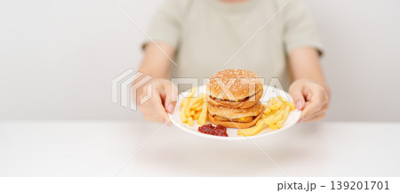 happy woman eating Juicy beef burger with melted cheddar cheese, potato chips. Unhealthy, High calorie, Fast food craving, Obesity, diet, weight loss, junk food and lifestyle happy woman eating Juicy beef burger with melted cheddar cheese, potato chips. Unhealthy, High calorie, Fast food craving, Obesity, diet, weight loss, junk food and lifestyle 139201701