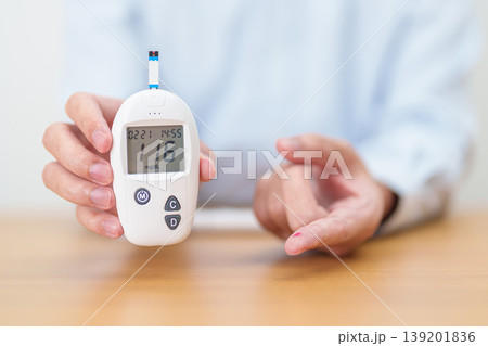 Hand checking Diabetes or Blood glucose self testing by digital blood glucose meter with lancet pen. high blood sugar level, World Diabetes Day, Glycemia, Hypoglycemia, Hyperglycemia and insulin Hand checking Diabetes or Blood glucose self testing by digital blood glucose meter with lancet pen. high blood sugar level, World Diabetes Day, Glycemia, Hypoglycemia, Hyperglycemia and insulin 139201836