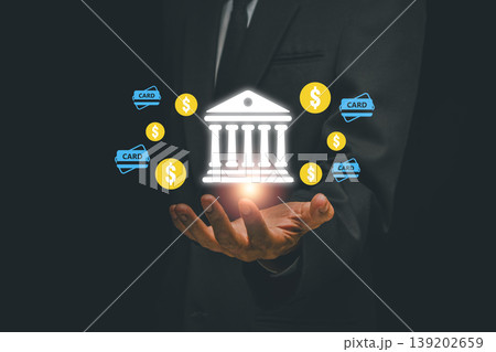 Businessman holding digital banking icons, symbolizing fintech and online transactions, in a modern business setting. Businessman holding digital banking icons, symbolizing fintech and online transactions, in a modern business setting. 139202659