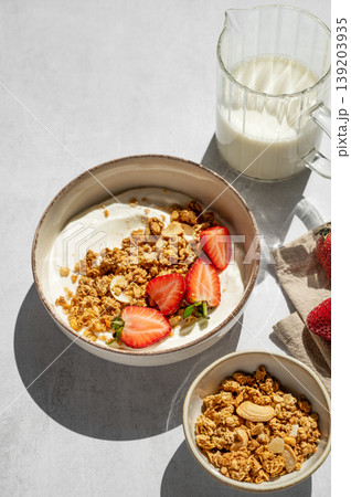 Balanced breakfast with yogurt, granola and strawberry on light background. Top view Balanced breakfast with yogurt, granola and strawberry on light background. Top view 139203935