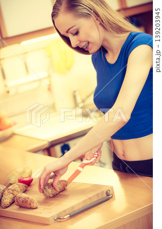 Woman preparing healthy breakfast making sandwich Woman preparing healthy breakfast making sandwich 139203945