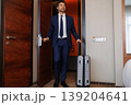 Successful Businessman Arriving Inside Hotel Room With Rolling Suitcase 139204641
