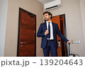 Stylish Business Man In Hotel Room Adjusting Tie After Arrival 139204643